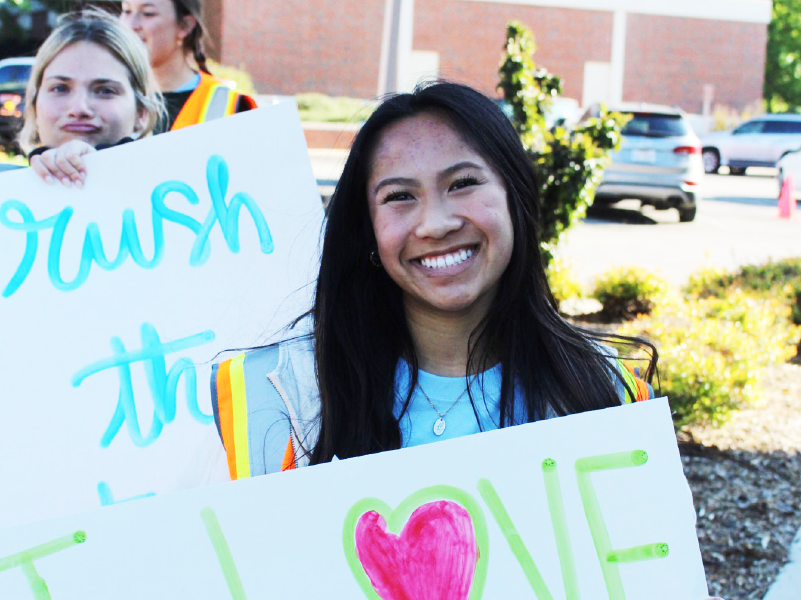 Happy students welcoming volunteers
